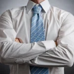 Man in white shirt with folded arms